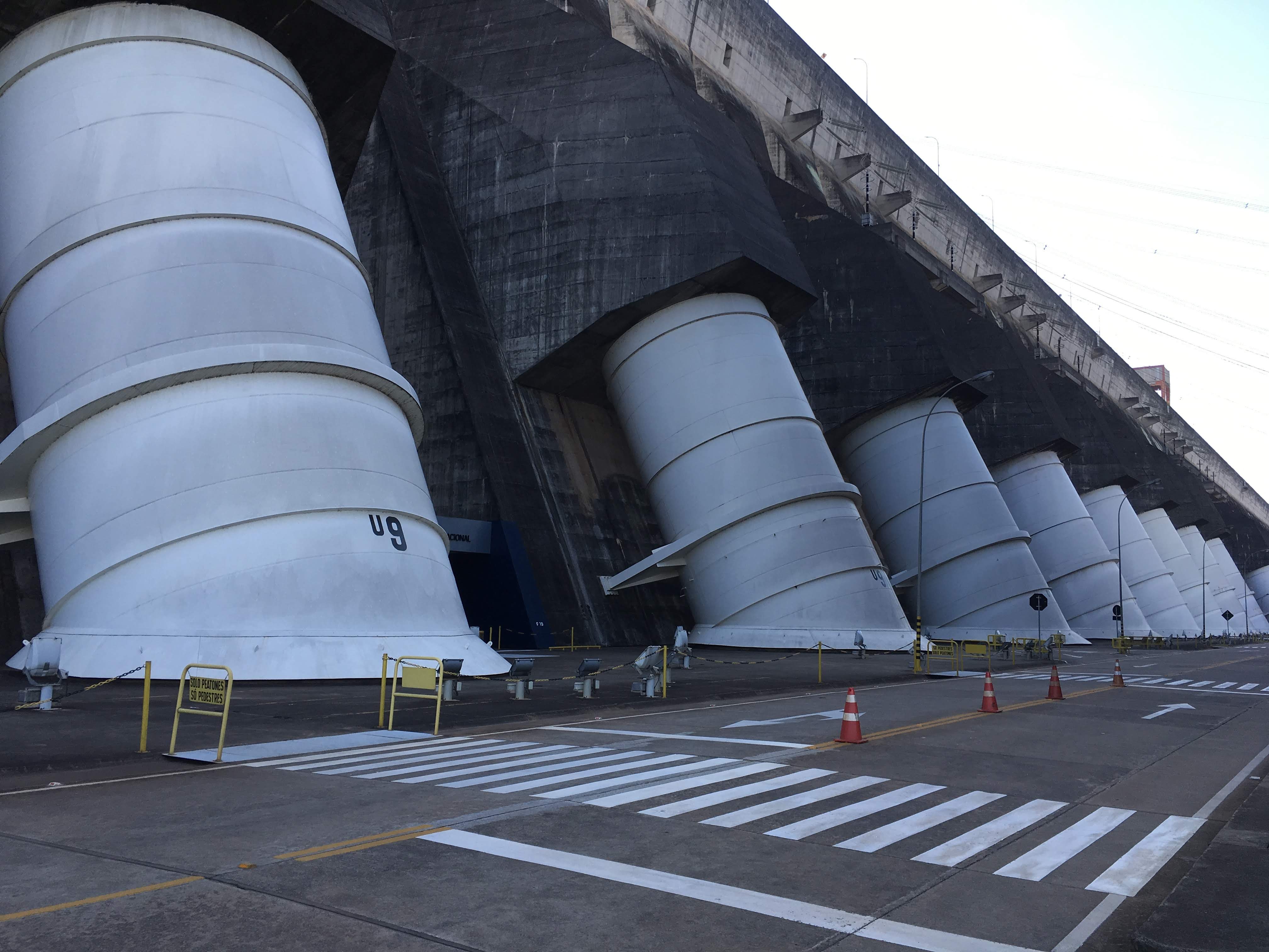 Large white tubes encasing water intake at dam.